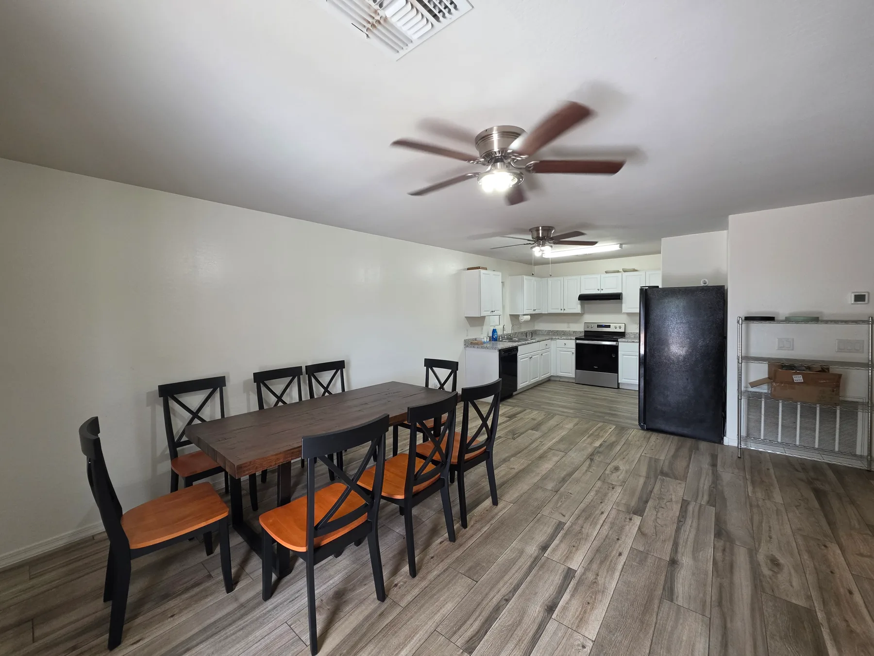 Open living and dining area with a kitchen beyond